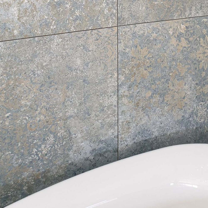 Close-up of Boheme Ocean Blue 60 × 60cm patterned tiles, featuring layered blue and neutral tones with a softly worn, decorative effect. Ideal for adding texture and character to bathroom walls, floors, or statement feature areas.