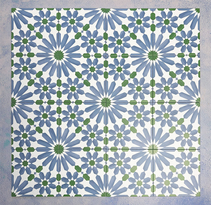 Arrangement of Fizaan Ocean 20x20cm Moroccan-style porcelain tiles, showcasing a repeating geometric pattern in blue, green and white tones.