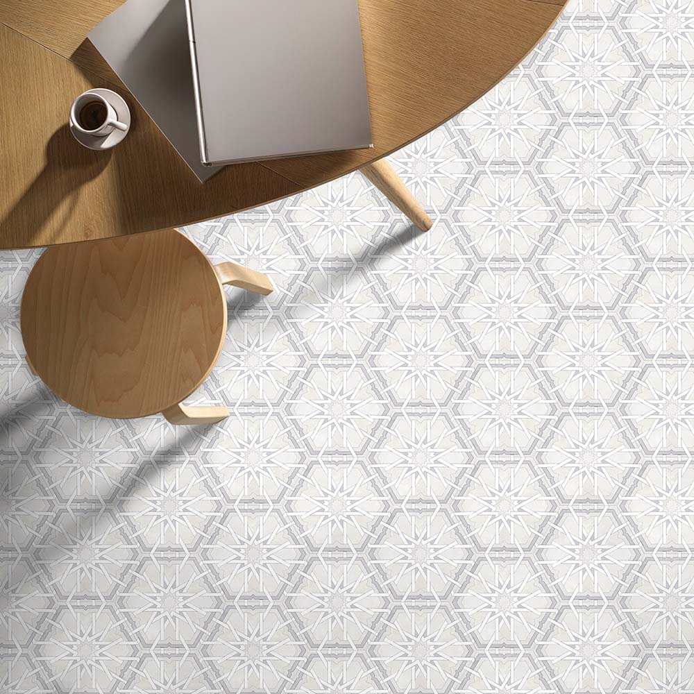 Maroush Mareshan Ice White 18.7x21.6cm Moroccan hexagonal tiles featuring an intricate white and grey geometric floral pattern, styled in a modern office setting with a wooden table and chair.