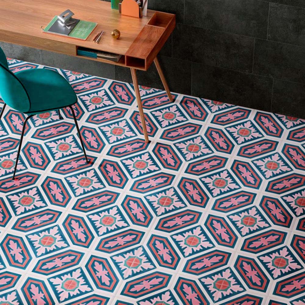 Interior workspace featuring Europa Vienna 20x20cm Victorian Moroccan style floor tiles in blue, pink and white tones, styled with a wooden desk, green chair and dark wall tiles in a contemporary office setting.