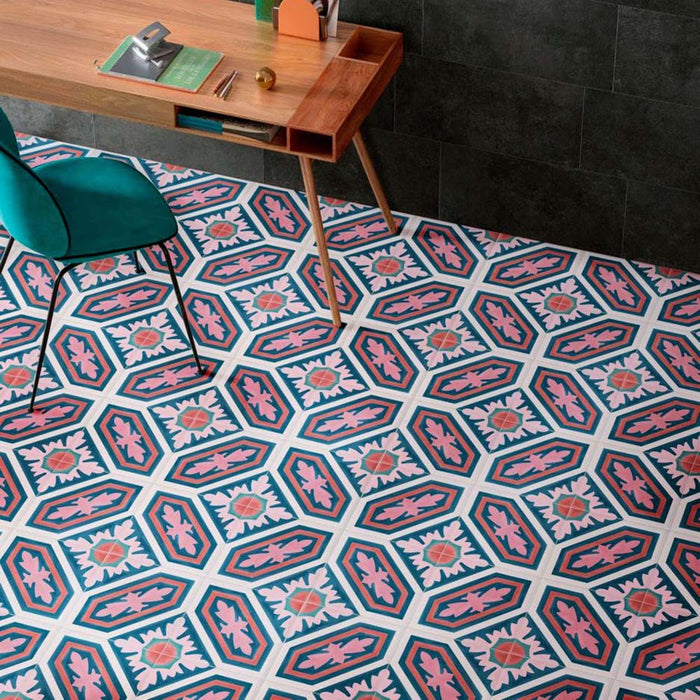 Interior workspace featuring Europa Vienna 20x20cm Victorian Moroccan style floor tiles in blue, pink and white tones, styled with a wooden desk, green chair and dark wall tiles in a contemporary office setting.