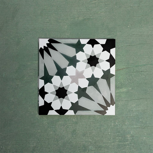 Single Fizaan Orchid Green 20x20cm Moroccan-style porcelain tile featuring a bold geometric pattern in green, black and soft neutral tones.