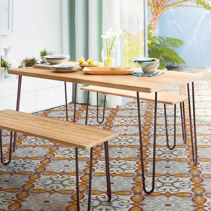 Dining area featuring Palma Gela 2cm patterned outdoor slabs 50 × 100cm, showcasing a decorative Mediterranean-inspired pattern in warm terracotta, grey, and white tones, paired with natural wood dining furniture and soft neutral interiors.