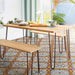 Dining area featuring Palma Gela 2cm patterned outdoor slabs 50 × 100cm, showcasing a decorative Mediterranean-inspired pattern in warm terracotta, grey, and white tones, paired with natural wood dining furniture and soft neutral interiors.