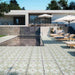 Modern outdoor pool area featuring Palma Olbia 2cm patterned outdoor slabs 50 × 100cm, showcasing a faded Mediterranean-inspired design in soft green and neutral tones, paired with sun loungers and contemporary architecture.