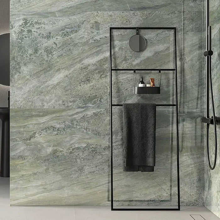 Bathroom featuring Paradis Marble Verde Green stone marble effect porcelain wall tiles in a 30cm x 60cm format, showcasing dramatic green, sage and soft white veining inspired by natural marble, paired with a contemporary walk-in shower, black shower screen, matte black brassware and minimalist accessories for a striking, luxurious bathroom design.