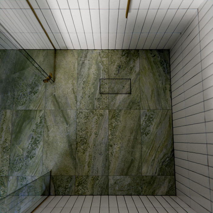 Bathroom featuring Paradis Marble Verde Green stone marble effect porcelain wall tiles in a 30cm x 60cm format, showcasing flowing green, sage and soft white veining inspired by natural marble, paired with a freestanding white bath, brushed brass brassware, neutral accessories and soft natural lighting for a luxurious spa-inspired interior.