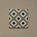 Single tile from the Carnaby Park Road Victorian-style collection, 20x20cm porcelain wall and floor tile, featuring a repeating diamond geometric pattern in olive, white, and black tones.