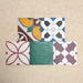 Fihrdos Patchwork Moroccan-style 20x20cm patterned porcelain tiles arranged in a mini group, highlighting a selection of colourful geometric and traditional decorative designs.