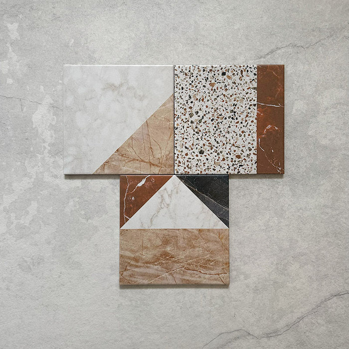 Flatlay featuring Dino Terrazzo Blanco Decor 20x20cm terrazzo-style ceramic tiles, showing a group of patchwork designs with mixed geometric patterns in white, terracotta, green, and black tones.