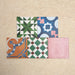 Fihrdos Patchwork Moroccan-style 20x20cm patterned porcelain tiles arranged in a mini group, highlighting a selection of colourful geometric and traditional decorative designs.