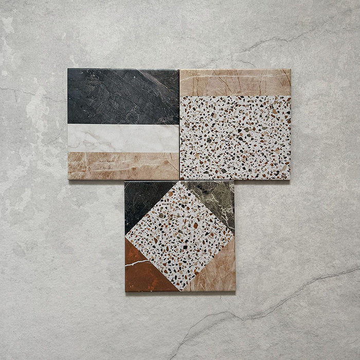 Flatlay featuring Dino Terrazzo Blanco Decor 20x20cm terrazzo-style ceramic tiles, showing a group of patchwork designs with mixed geometric patterns in white, terracotta, green, and black tones.