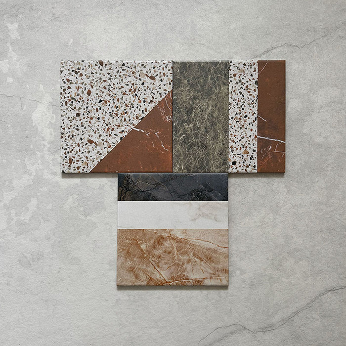 Flatlay featuring Dino Terrazzo Blanco Decor 20x20cm terrazzo-style ceramic tiles, showing a group of patchwork designs with mixed geometric patterns in white, terracotta, green, and black tones.