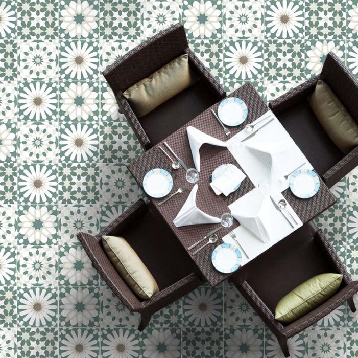 Dining room featuring Soukaina Green B Moroccan-style 20cm x 20cm patterned porcelain floor tiles laid in a mixed patchwork design, with soft green, white and neutral geometric motifs beneath a square dining table.