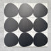Pebble Beach Reversed Black 20x20cm patterned tiles featuring a bold black organic circular design, ideal for creating striking monochrome floors and statement walls with a contemporary geometric aesthetic.