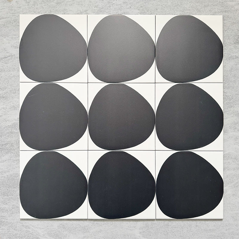 Pebble Beach Reversed Black 20x20cm patterned tiles featuring a bold black organic circular design, ideal for creating striking monochrome floors and statement walls with a contemporary geometric aesthetic.