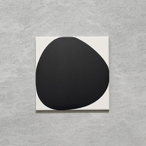 Pebble Beach Reversed Black 20x20cm patterned tiles featuring a bold black organic circular design, ideal for creating striking monochrome floors and statement walls with a contemporary geometric aesthetic.