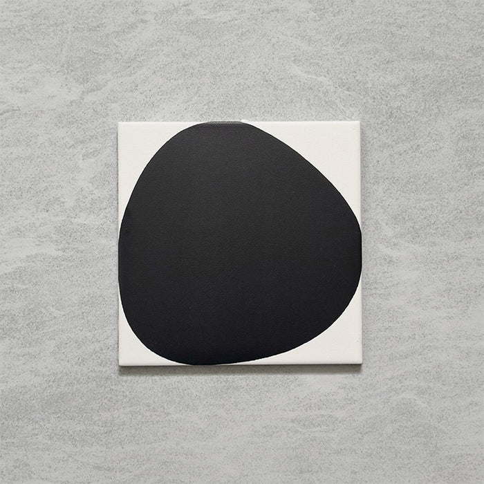 Pebble Beach Reversed Black 20x20cm patterned tiles featuring a bold black organic circular design, ideal for creating striking monochrome floors and statement walls with a contemporary geometric aesthetic.