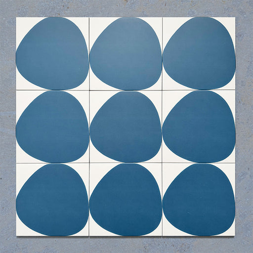 Pebble Beach Reversed Blue 20x20cm patterned tiles featuring a bold deep blue organic circular design, ideal for creating playful statement walls and contemporary patterned floors with a modern geometric feel.