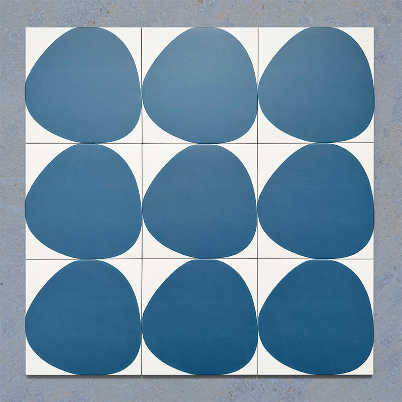 Pebble Beach Reversed Blue 20x20cm patterned tiles featuring a bold deep blue organic circular design, ideal for creating playful statement walls and contemporary patterned floors with a modern geometric feel.