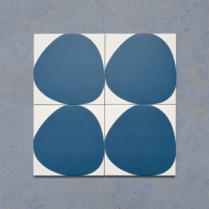 Pebble Beach Reversed Blue 20x20cm patterned tiles featuring a bold deep blue organic circular design, ideal for creating playful statement walls and contemporary patterned floors with a modern geometric feel.