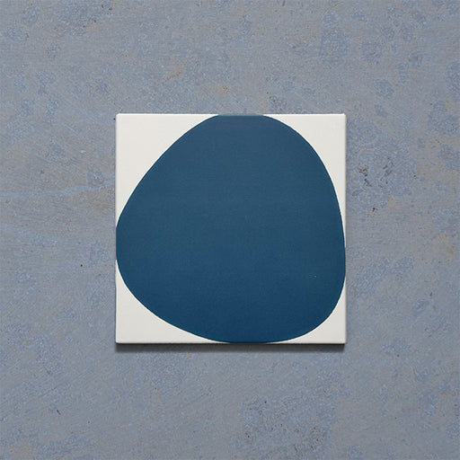 Pebble Beach Reversed Blue 20x20cm patterned tiles featuring a bold deep blue organic circular design, ideal for creating playful statement walls and contemporary patterned floors with a modern geometric feel.