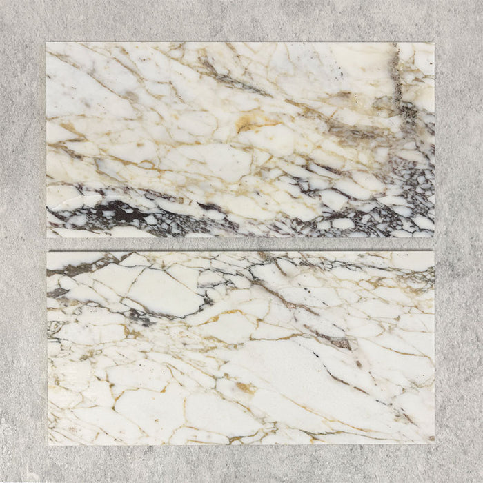 Close-up of Fitzrovia Picasso natural marble tiles in a honed finish, 30.5x61cm format, showcasing a soft white base with warm beige undertones and distinctive, organic veining, creating a refined and elegant look for wall and floor applications.