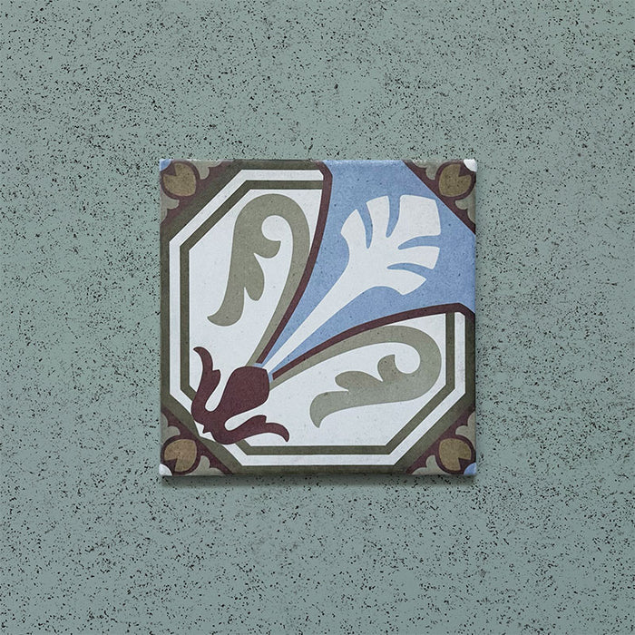 Single tile from the Carnaby Place Victorian-style collection, 20x20cm porcelain wall and floor tile, featuring an ornate floral motif in olive, blue, cream, and deep red tones on an aged background.