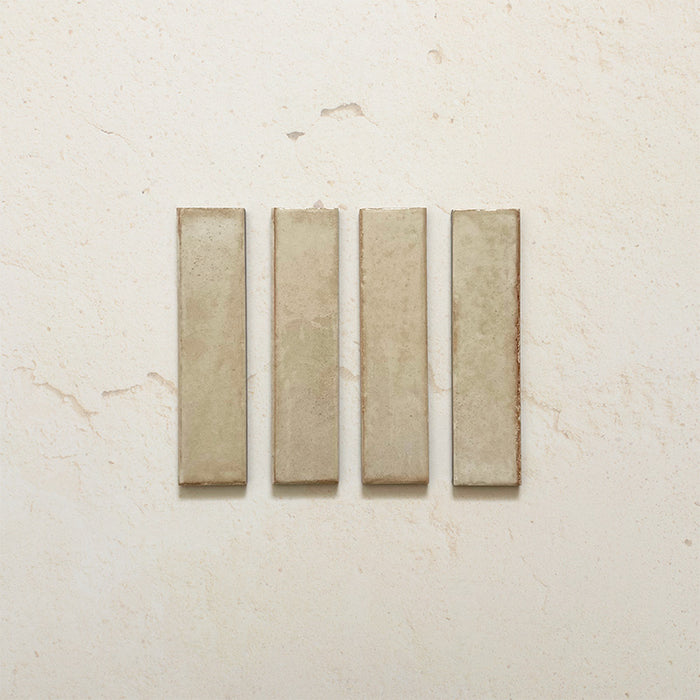 Product image of Play Cream Rectified Brick 5x20cm wall and floor tiles, featuring a glossy cream finish with subtle tonal variation and clean rectified edges, displayed to highlight the tile's contemporary handcrafted appearance.