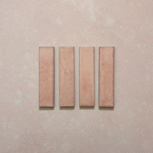 Product image of Play Rose Rectified Brick 5x20cm wall and floor tiles, featuring a glossy blush pink finish with soft tonal variation and clean rectified edges, displayed to highlight the tile's contemporary handcrafted appearance.