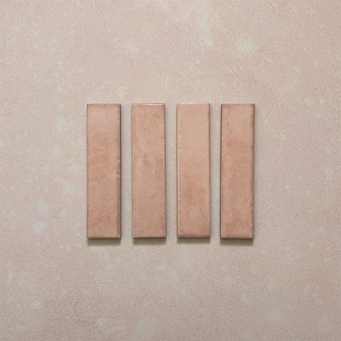 Product image of Play Rose Rectified Brick 5x20cm wall and floor tiles, featuring a glossy blush pink finish with soft tonal variation and clean rectified edges, displayed to highlight the tile's contemporary handcrafted appearance.