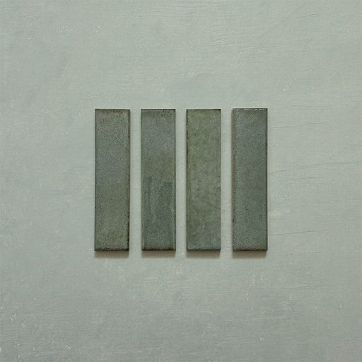 Product image of Play Sage Green Rectified Brick 5x20cm wall and floor tiles, featuring a glossy sage green finish with subtle tonal variation and clean rectified edges, displayed to highlight the tile's contemporary handcrafted appearance.