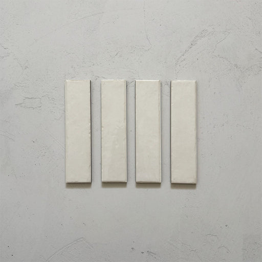Product image of Play White Rectified Brick 5x20cm wall and floor tiles, featuring a glossy white finish with subtle tonal variation and clean rectified edges, displayed to highlight the tile's contemporary handcrafted appearance.