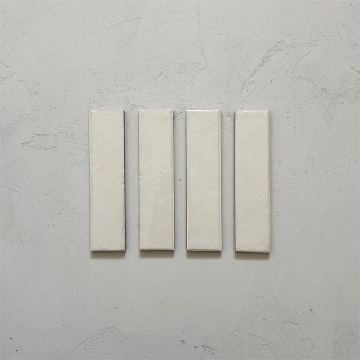 Product image of Play White Rectified Brick 5x20cm wall and floor tiles, featuring a glossy white finish with subtle tonal variation and clean rectified edges, displayed to highlight the tile's contemporary handcrafted appearance.