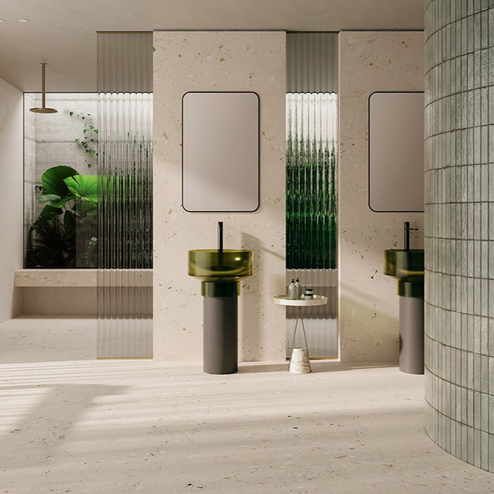 Contemporary bathroom featuring Riminy Light Cosmo Stone wall and floor tiles 60 × 120cm, showcasing soft ivory stone-effect tones with subtle aggregate detailing, paired with green glass basins, fluted glass panels, and minimalist fittings.