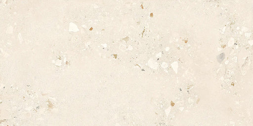 Close-up of Riminy Light Cosmo Stone wall and floor tiles 60 × 120cm, featuring soft ivory stone-effect tones with subtle aggregate detailing, delicate texture, and a refined contemporary matt finish.