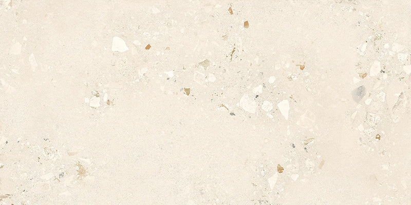 Close-up of Riminy Light Cosmo Stone wall and floor tiles 60 × 120cm, featuring soft ivory stone-effect tones with subtle aggregate detailing, delicate texture, and a refined contemporary matt finish.
