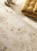 Living space featuring Riminy Sand Cosmo Stone wall and floor tiles 60 × 120cm, designed with a warm terrazzo-effect surface, scattered stone fragments, and soft sand-toned concrete detailing, paired with mustard velvet seating for a refined contemporary interior.