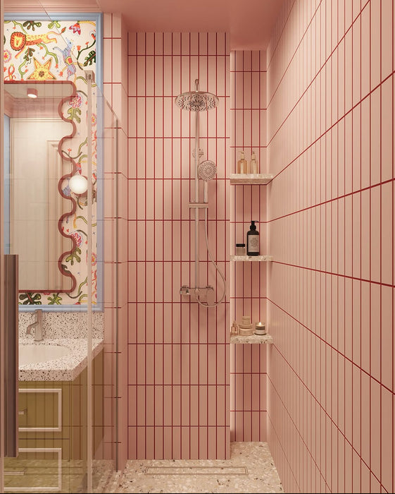 Bathroom interior featuring Rippled Brick Base Stony Pink 5 × 20cm matt ceramic wall tiles, laid vertically with fine linear detail, paired with a glass shower enclosure, terrazzo-effect flooring, and a playful, colour-led vanity area.