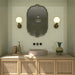 Contemporary bathroom featuring Rippled Brick Tansy Green 5cm x 20cm gloss wall tiles, laid vertically and paired with a wooden cane vanity, decorative mirror and brass lighting.