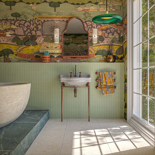 Bathroom featuring Rippled Brick Base Tansy Green Matt 5cm x 20cm wall tiles, laid vertically and paired with decorative wallpaper, a freestanding stone bath, vintage basin and copper fittings.