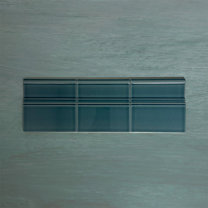 Flat lay of Finchley River Blue 15 × 15cm ceramic skirting tiles with a crackle glaze finish, designed to create a smooth, decorative transition between wall and floor in classic interior spaces.