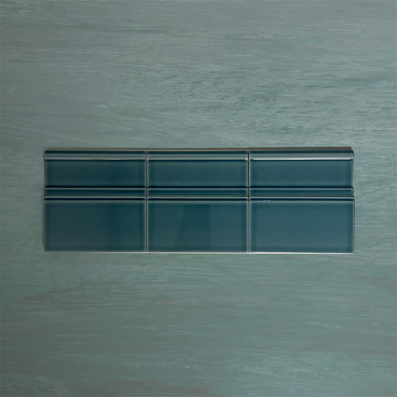 Flat lay of Finchley River Blue 15 × 15cm ceramic skirting tiles with a crackle glaze finish, designed to create a smooth, decorative transition between wall and floor in classic interior spaces.