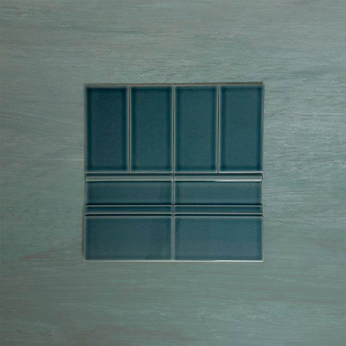 Flat lay showing Finchley River Blue 7.5 × 15cm ceramic wall tiles with a crackle glaze finish, paired with matching 15 × 15cm skirting tiles to create a classic, cohesive wall and floor tile detail.