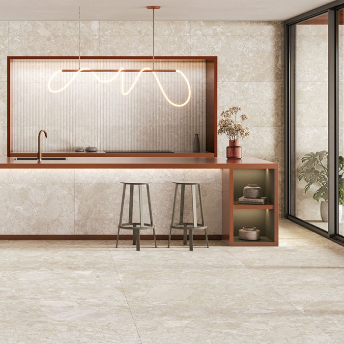 Kitchen interior featuring Contract Pebble Rock Avorio 60x120cm terrazzo effect porcelain wall and floor tiles, styled with a modern island, ribbed splashback detail, bar stools, and warm terracotta accents for a contemporary finish.