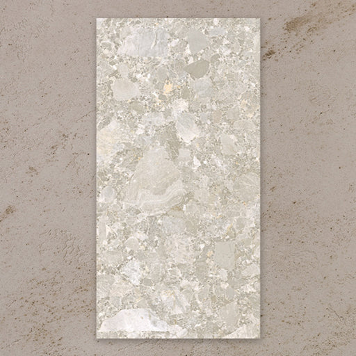 Single tile view of Contract Pebble Rock Avorio 60x120cm terrazzo effect porcelain tile, showcasing soft beige and ivory tones with varied stone fragments and a natural, blended surface pattern.
