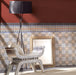 Empire Blue 15x15cm Victorian tiles used in an elegant room setting, featuring intricate floral and geometric motifs in blue, terracotta, grey, and white tones with matching decorative borders for a classic heritage interior.