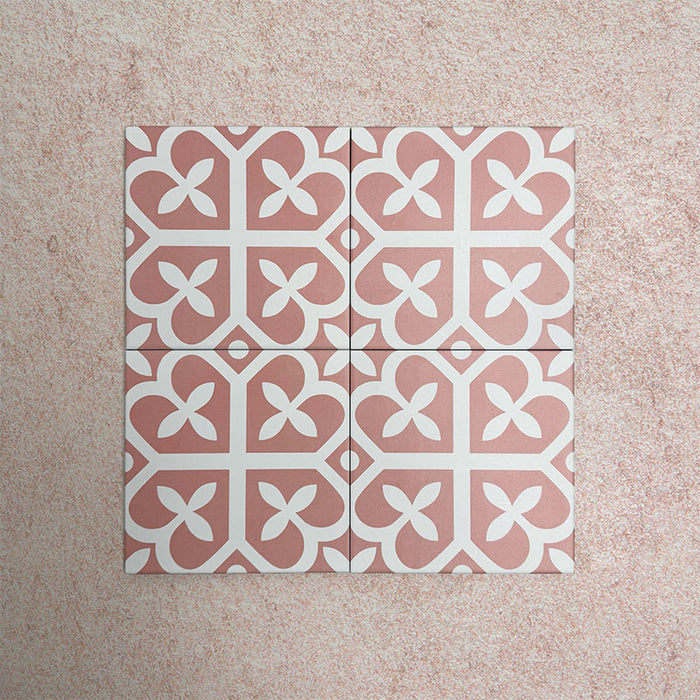 Iris Pink Victorian Moroccan-style 20x20cm patterned porcelain tiles arranged in a tiled group, showcasing a soft pink and white geometric design.