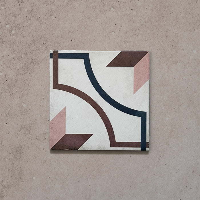 Single tile of the Carnaby Rose Victorian-style 20x20cm porcelain wall and floor tile, featuring a pink, brown, and navy geometric pattern on a soft aged white background.