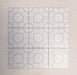 Arrangement of Fizaan Pink Rose 20x20cm Moroccan-style porcelain tiles, showcasing a repeating geometric pattern in soft pink and white tones.